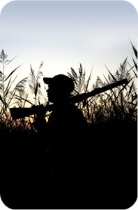 Silhouette of a hunter in a marsh